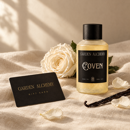 Garden Alchemy gift card on linen with a white rose